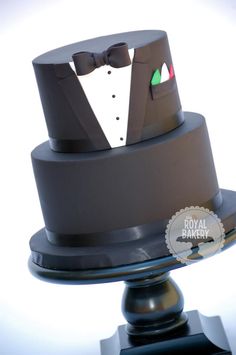 a cake with a tuxedo and bow tie on it's top tier