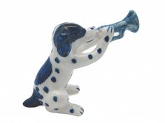 a blue and white dog figurine with a trumpet in it's mouth