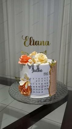 a birthday cake with flowers on it sitting on a table