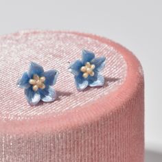 These charming stud earrings feature delicate flowers crafted from vibrant blue resin. The elegant design is perfect for adding a touch of color to any outfit, while the high-quality resin ensures lasting durability. Whether you're dressing up for a special occasion or simply want to add some floral flair to your everyday look, these earrings are a beautiful choice. * Dimensions: 10 x 10 mm | 0.4'' x 0.4'' * Material: Silver, Resin * Finish: Silver OTHER ∙ INFORMATION * All items are nicely pack Resin Flowers, Flower Earrings Studs, Flower Studs, Delicate Flower, Everyday Jewelry, Jewelry Bags, Silver Earrings Studs, Flower Crafts, Jewelry Earrings Studs