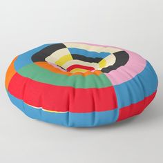 a multicolored round floor pillow on a white background