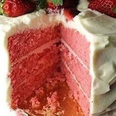 a red velvet cake with white frosting and strawberries