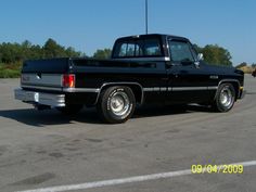 a black pickup truck parked in a parking lot