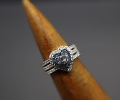 a diamond ring sitting on top of a wooden stick