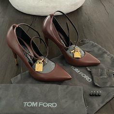 Tom Ford Padlock Ankle Wrap Leather Pump In The Perfect Brown Color With Yellow Golden Hardware. Size 37. In Like New Condition. Never Got To Wear These Out Just Like The Black Ones I Have Up. Sad To Let Them Go. You Can Wear Them With Or Without The Ankle Wrap. Beautiful Pumps! Dust Bags And Extra Heel Tips, But No Box. Glamorous Brown Pointed Toe Heels, Leather Heels With Gold-tone Hardware And Pointed Toe, Gold Tom Ford Heels, Evening Heels With Gold-tone Hardware In Leather, Black Tom Ford Heels, Tom Ford Shoes, Let Them Go, Ankle Wrap, Leather Pumps