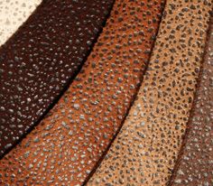 the different colors of leather are shown in close up view, including brown, black, and tan