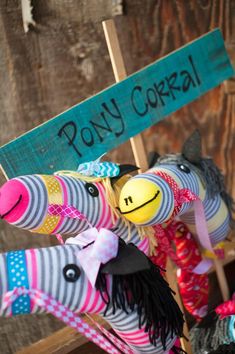 several stuffed animals are on display with a sign that says pony corral in front of them