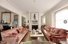 a living room filled with furniture and a fire place in the middle of a room