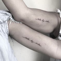 two women's arm tattoos with words on them