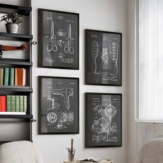 three framed drawings hang on the wall above a chair