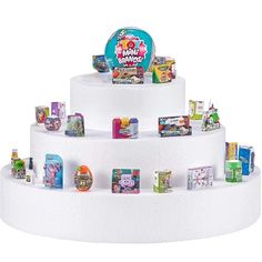 there is a three tiered cake that has many different items on top of it