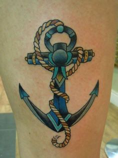 an anchor tattoo on the side of a woman's lower leg, with a rope around it