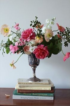 a vase filled with lots of pink and white flowers