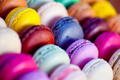 colorful macaroons are lined up in a row