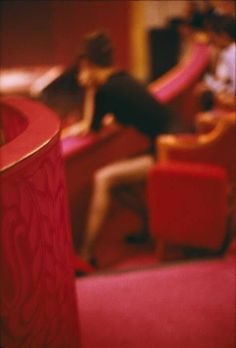 a blurry photo of a woman sitting in a chair with her feet on the table