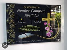 a plaque with flowers and a cross on it in front of a window that says nombre completo appetidos