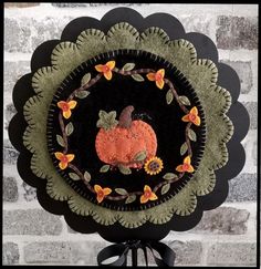 a black and green plate with a pumpkin on it