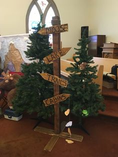 a small christmas tree with wooden signs on it