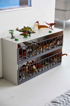 toy dinosaurs are sitting on top of the drawers