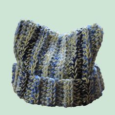 a blue and white knitted headband on a light green backgroung