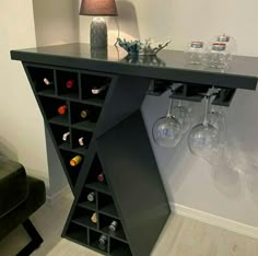 a table with wine glasses on it and a lamp in the corner next to it