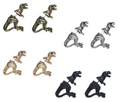 four different types of dinosaur brooches are shown in this image, one is black and the other is silver