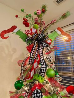 a christmas tree decorated with ornaments and ribbons