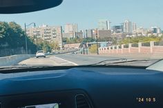 a view from inside a car looking at the city