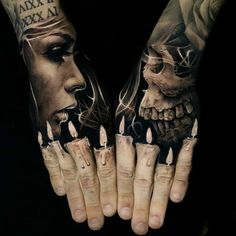 two hands that have tattoos on them, one with a skull and the other with a woman's face