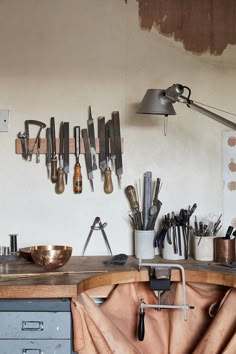 the kitchen counter is covered with knives and utensils