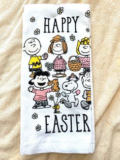 a towel with the words happy easter written on it and cartoon characters in front of them