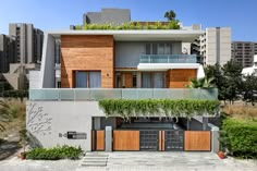 an apartment building with plants growing on the roof