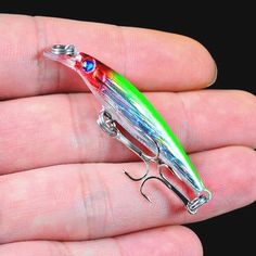 a small fishing lure in someone's hand