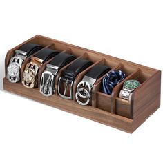 a wooden watch holder with six watches in it