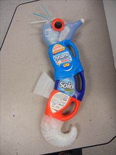 a pair of scissors sitting on top of a table next to a tube of toothpaste