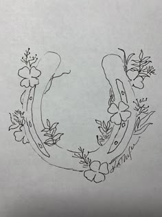 a drawing of a horseshoe with flowers on it