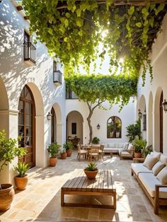 an outdoor patio with seating and potted plants on the side of the building,