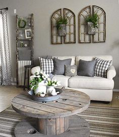 a living room with couches, tables and potted plants on the coffee table