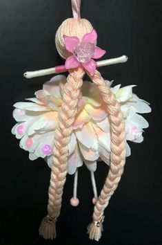 an ornament made to look like a fairy with pink hair and braids