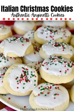 italian christmas cookies with white icing and sprinkles are on a plate