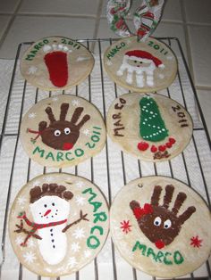 four decorated cookies sitting on top of a rack