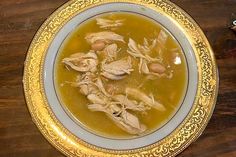 a bowl filled with soup sitting on top of a wooden table