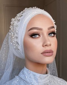 a mannequin wearing a white veil and headpiece