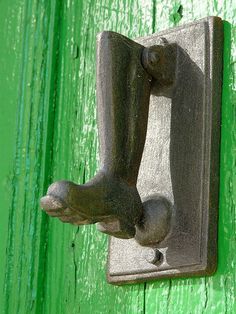 a door handle on a green wooden door