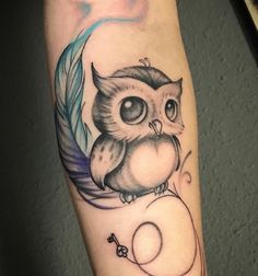 an owl tattoo on the left arm