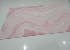 a pink area rug with wavy lines on it