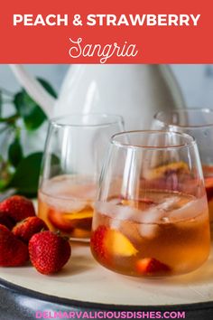 peach and strawberry sangria in glasses on a tray with strawberries next to it