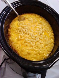 macaroni and cheese in a crock pot ready to be cooked for the oven