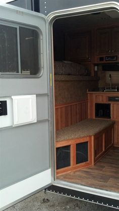 the inside of a horse trailer with its door open