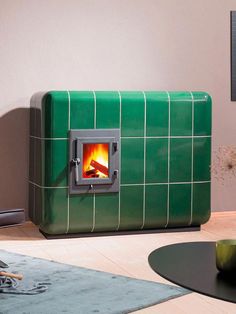 a green stove sitting in the middle of a living room